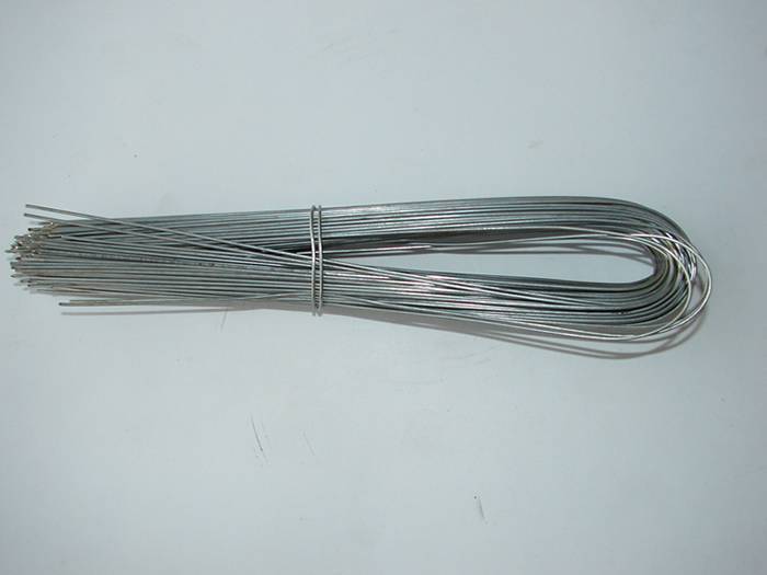  A bundle of galvanized U type wire on the gray background.