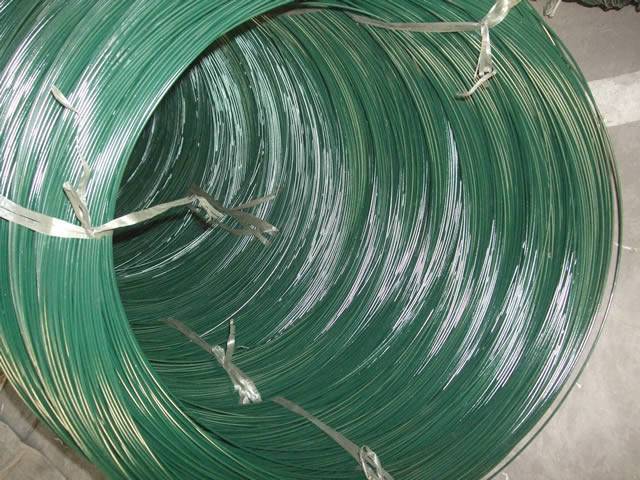 A big coils of green color PVC coated wires on the ground.