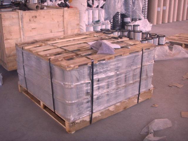 A pallet and a wooden box of spool wires in the warehouse.