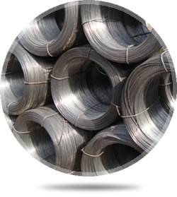 Several rolls of galvanized wires are piled on the ground.