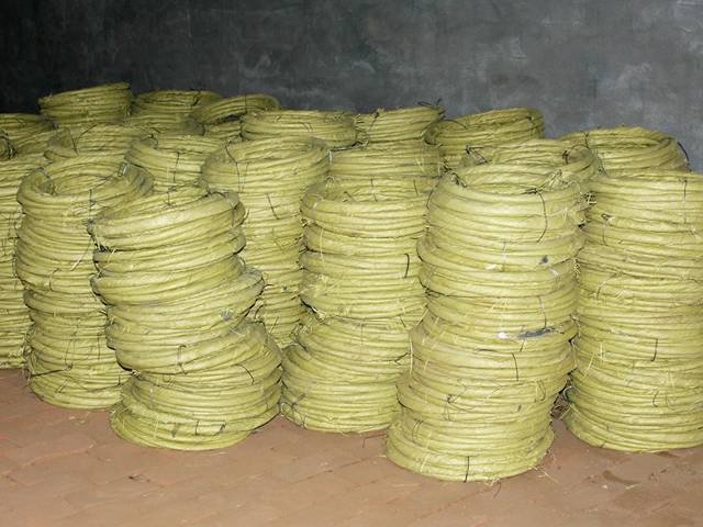 Several rolls of steel wires in yellow woven bag package on the ground.